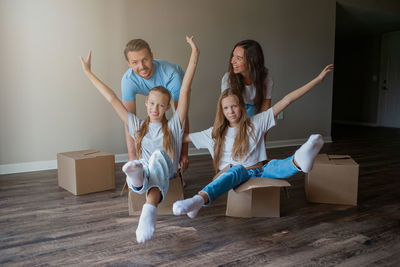 Portrait of happy family sitting on sofa at home