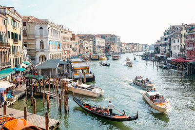 Boats in canal along buildings