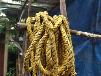 Close-up of rope tied up on rusty metal