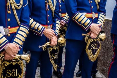 Midsection of soldiers standing outdoors