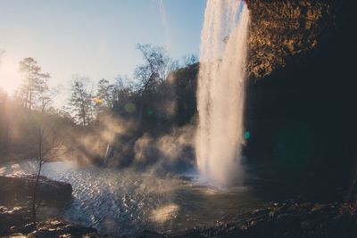 Scenic view of waterfall against sky