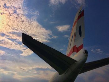 Low angle view of airplane flying against sky