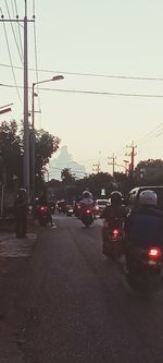 Traffic on road at sunset