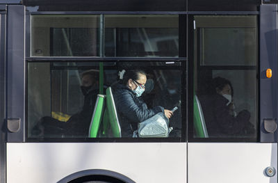 Reflection of man sitting in train