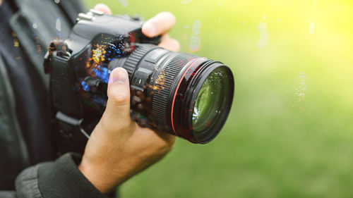 Midsection of man photographing camera