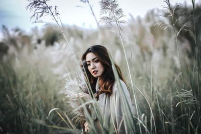 Portrait of beautiful woman on field