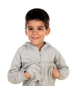 Portrait of smiling boy standing against white background