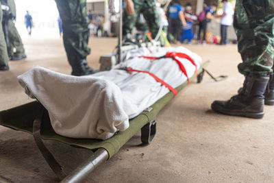 Low section of man lying on bed