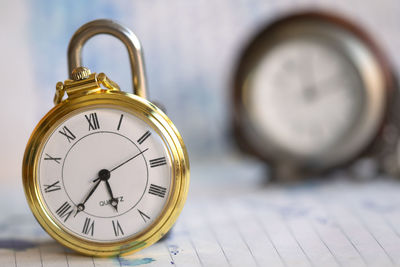 Close-up of pocket watch on table