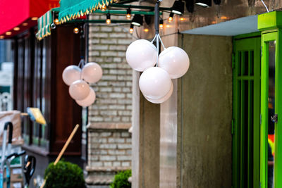 White balloons hanging on ceiling of building