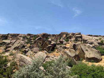 Rock formations on landscape against sky