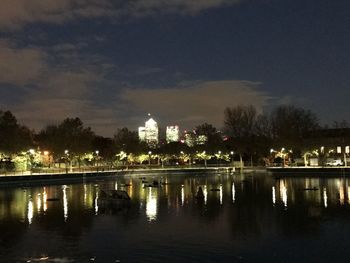 Reflection of city in river at night