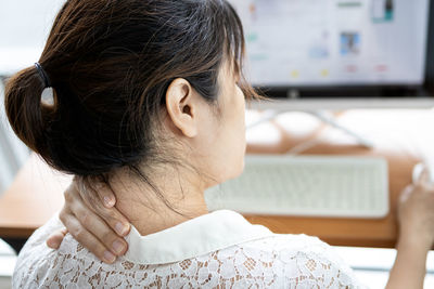 Portrait of woman using mobile phone at home