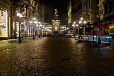 Illuminated city street at night