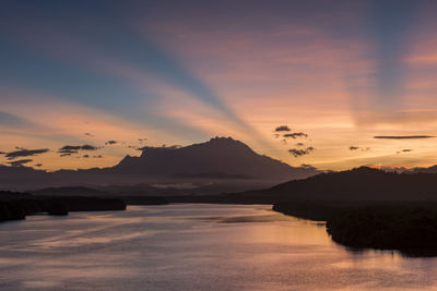 Scenic view of lake against romantic sky at sunset