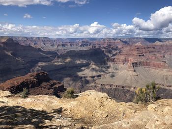 Scenic view of grand canyon mountains with partly-cloudy sky