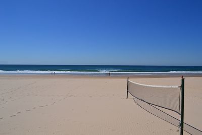 Scenic view of beach against clear blue sky