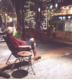 Full length of woman sitting at night