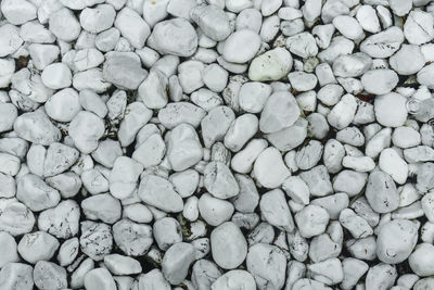 Top view of the bottom of the pool with clean, clear water. the bottom is covered with white pebbles