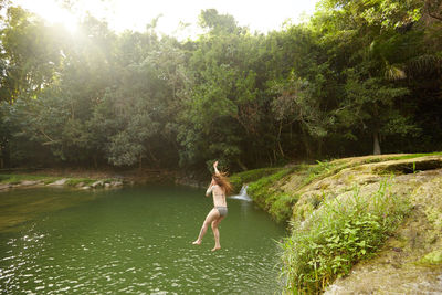 Full length of man jumping in river