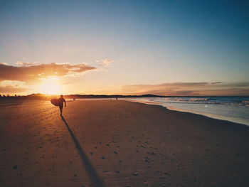 Scenic view of beach against sky during sunset