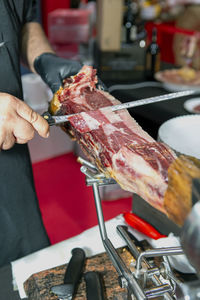 Close up shot cutting iberian ham