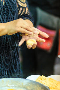 Close-up of hands and woman eating food