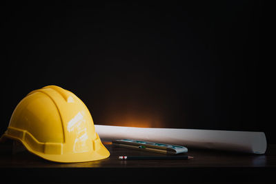 Close-up of illuminated lamp against black background