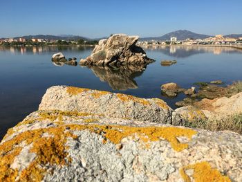 Scenic view of sea by harbor against sky