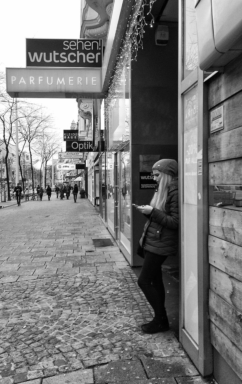 architecture, building exterior, built structure, text, the way forward, street, communication, western script, city, information sign, road sign, guidance, sign, cobblestone, road, transportation, day, outdoors, incidental people