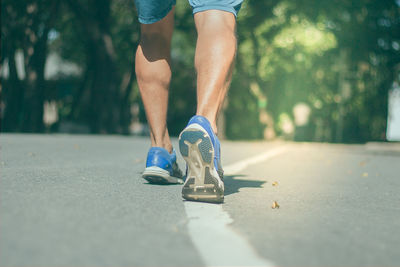 Low section of man running on street