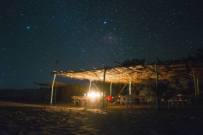 People on beach against sky at night