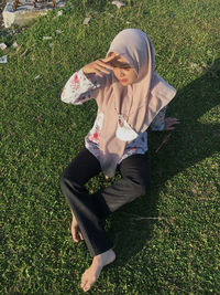 High angle view of woman holding umbrella on field