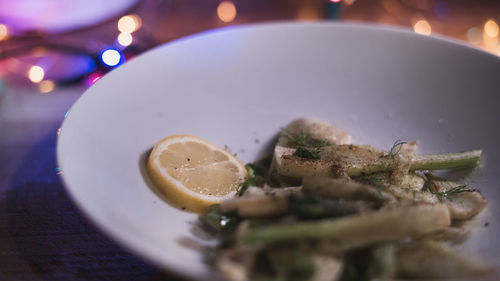 Close-up of chopped fruit in plate on table