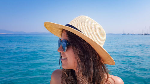 Close-up of woman wearing hat while looking away