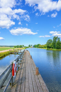 Pier over lake against sky