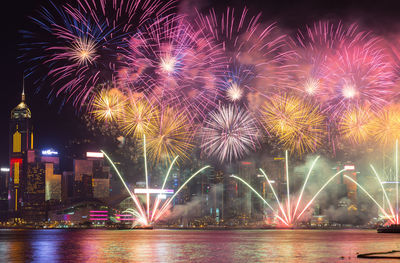 Firework display over river at night