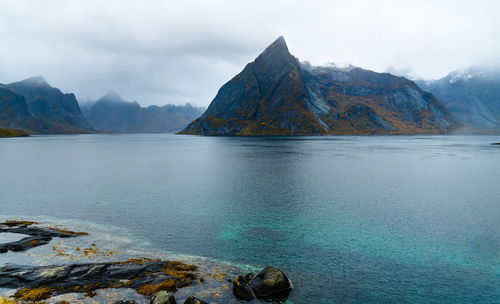 Scenic view of sea and mountains against sky