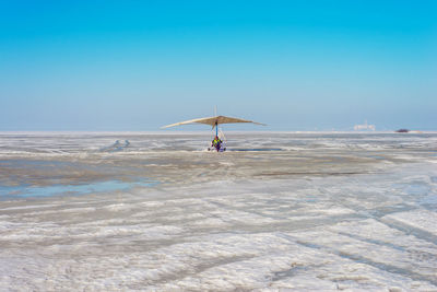 White sport hang glider on an ice field