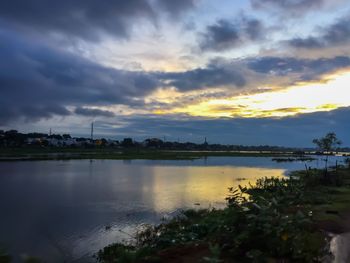 Scenic view of lake against cloudy sky