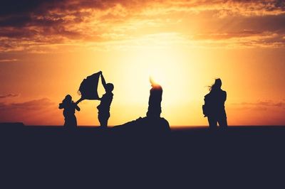 Silhouette of people at sunset