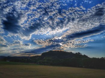 Scenic view of field against sky during sunset