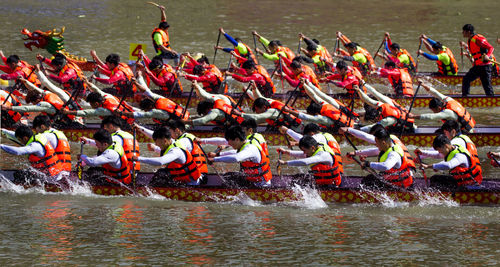 Group of people boat racing in water