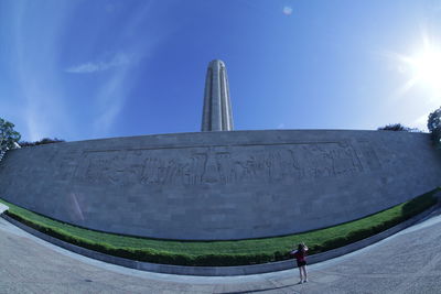 People at monument against sky