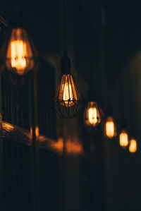 Close-up of illuminated pendant lights hanging from ceiling