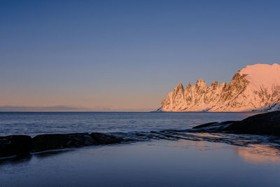 Scenic view of sea against clear sky at sunset