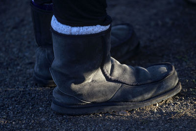 Low section of person wearing shoes standing outdoors