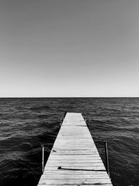 Pier over sea against clear sky