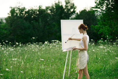 Side view of woman standing on field