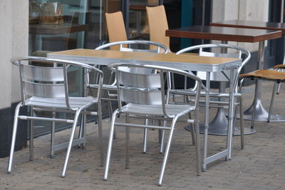 Empty chairs and tables in cafe